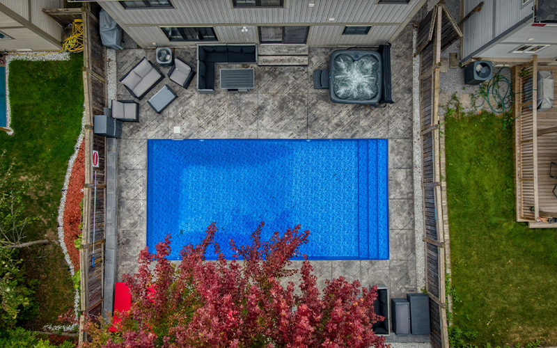 Pool in a backyard being shown from drone view